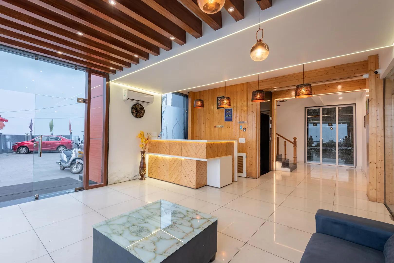 a reception desk with a stairs at mv acosta by lawrence hotel in mussoorie hotel_Image