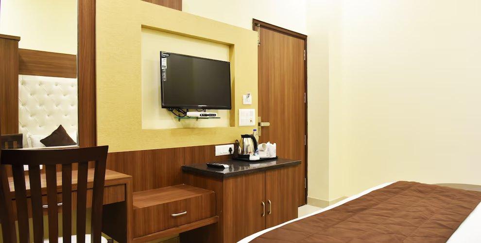 a bed room with t.v at hotel amritsar international in amritsar hotel_Image