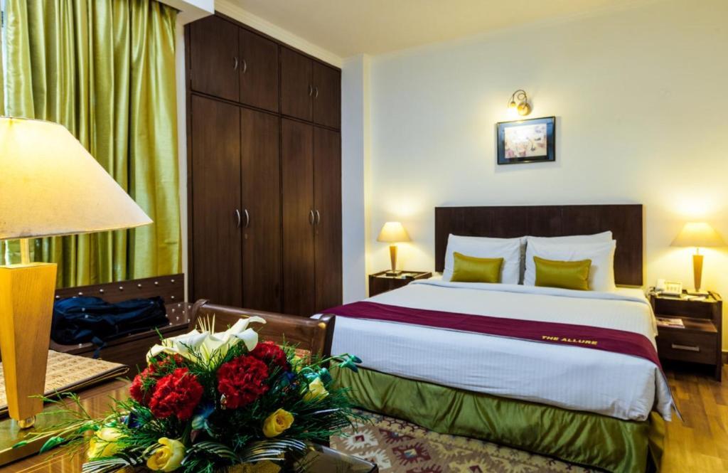 a bed room with sofa at goodwill hotel new in delhi hotel_Image