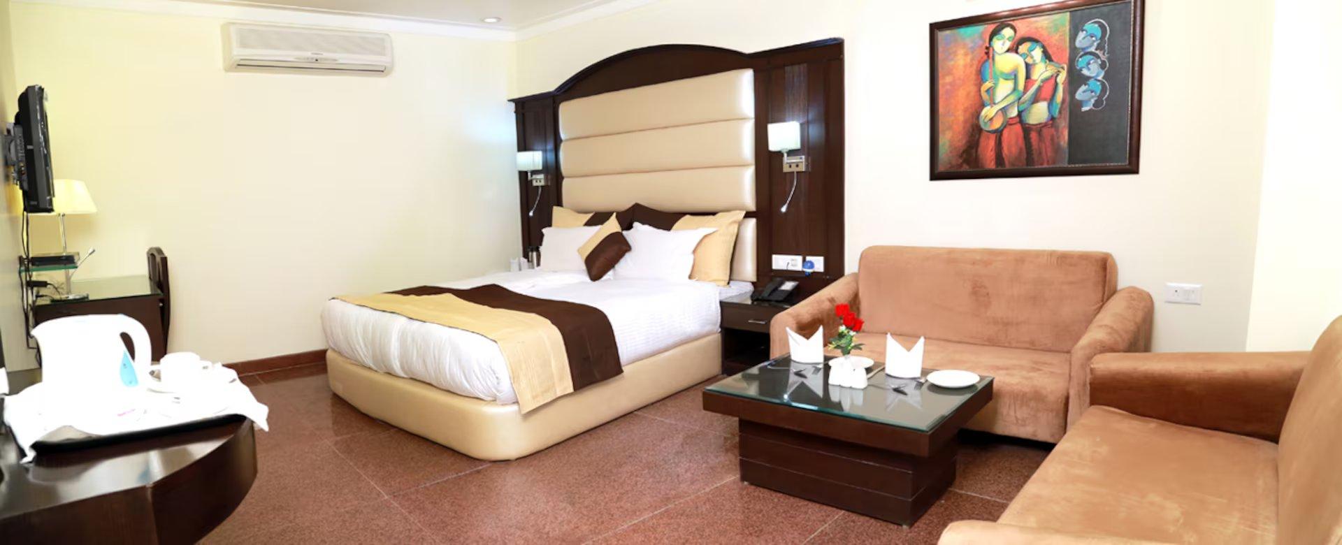 a bed room with t.v at hotel blue sapphire in agra hotel_Image