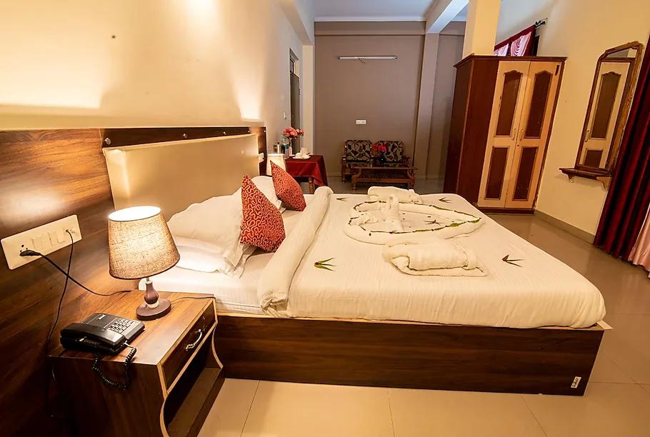 a bedroom with pillows and towel on bed at sidhhi vinayak in ranthambore hotel_Image