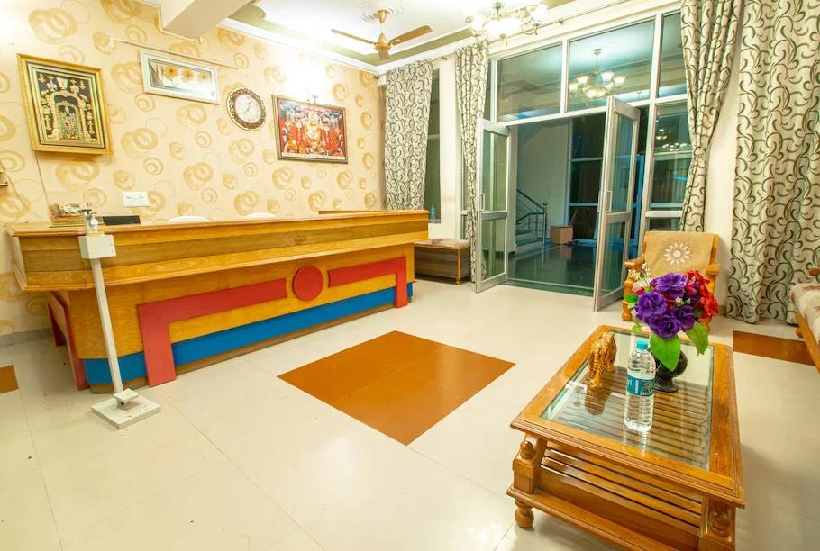 a reception desk with couches and a table at sidhhi vinayak in ranthambore hotel_Image