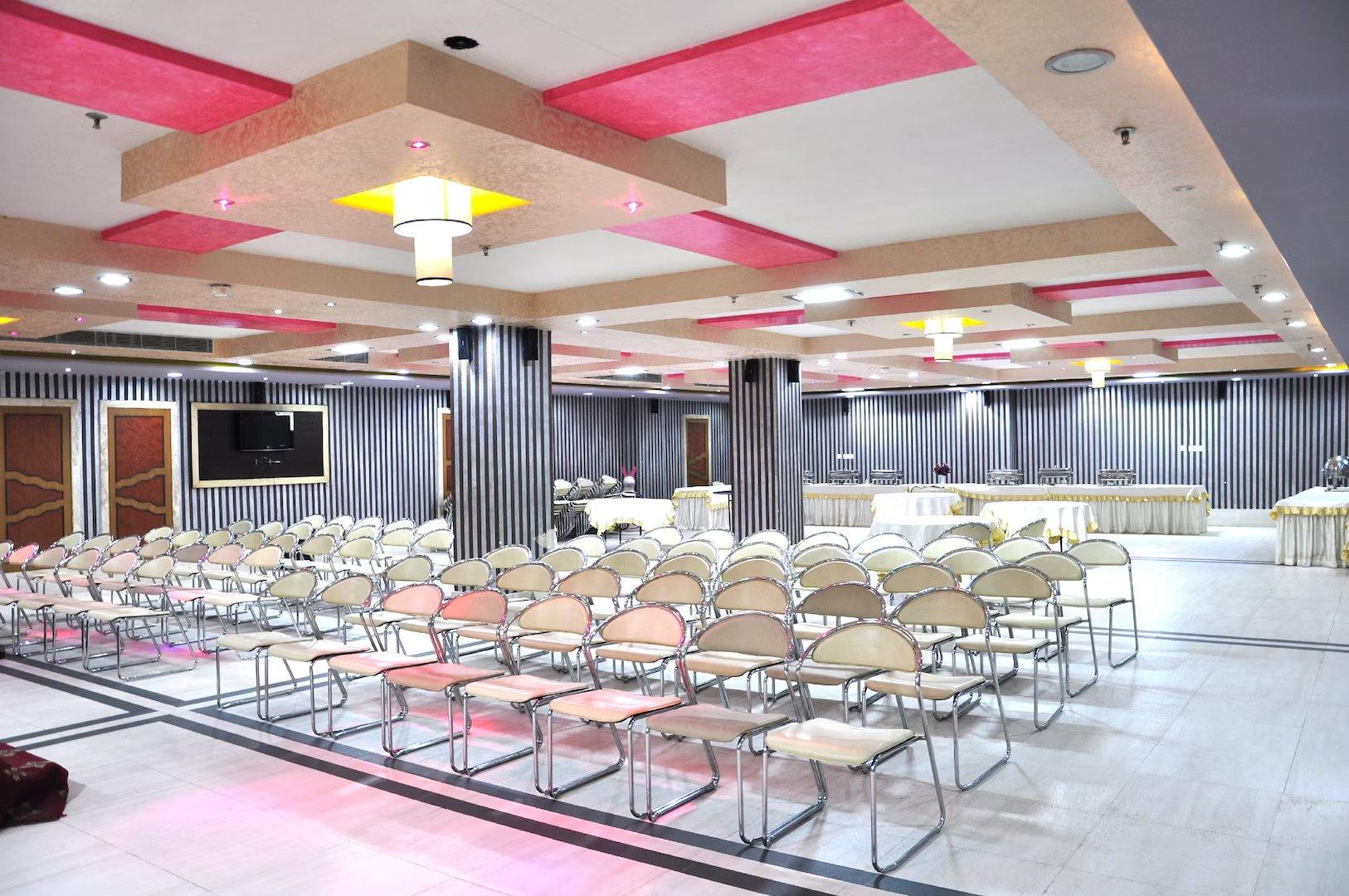 a hotel with hall area and chairs at sun hotel in agra hotel_Image