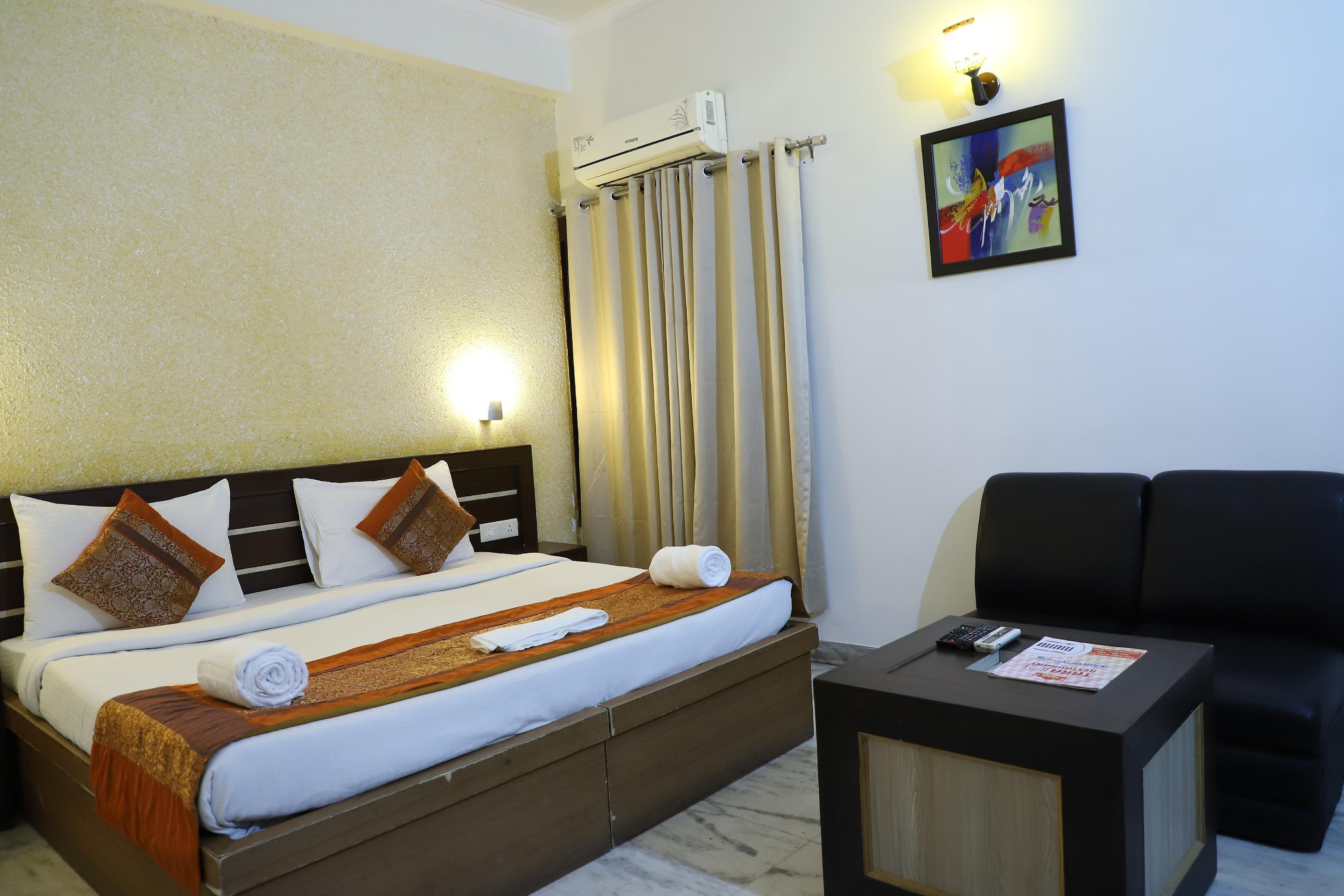 a bedroom with one bed and a tv at hotel tara palace in Agra hotel_Image
