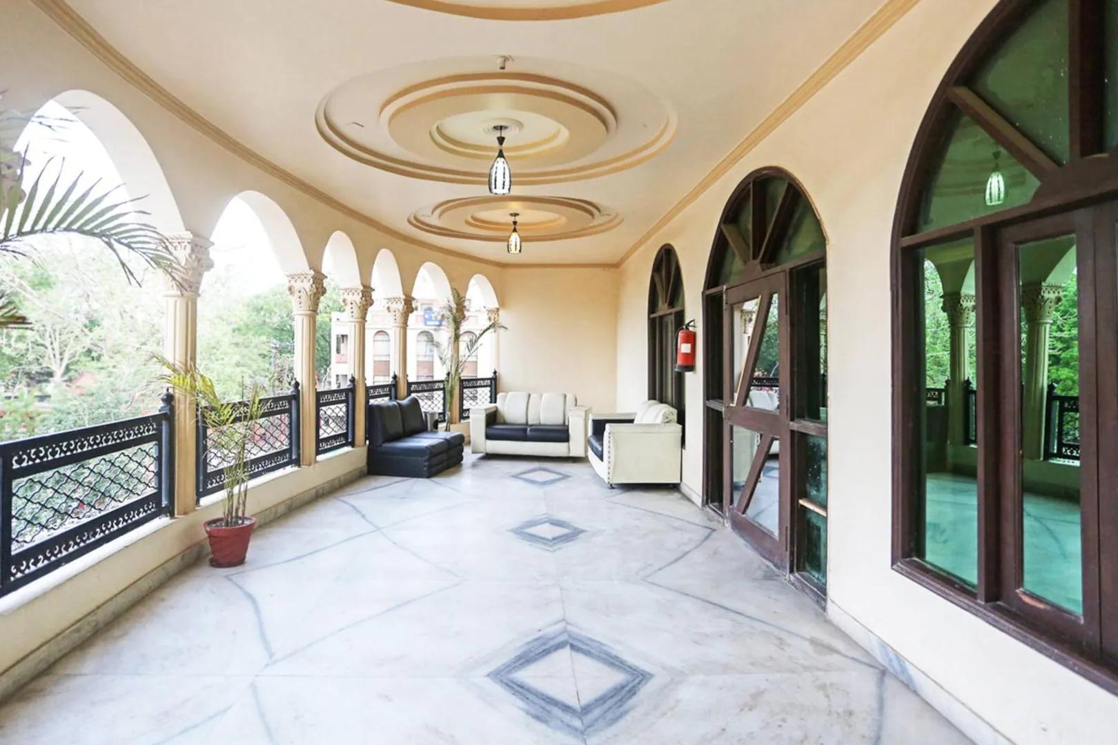 a balcony view with sofa and table at hotel tara palace in Agra hotel_Image