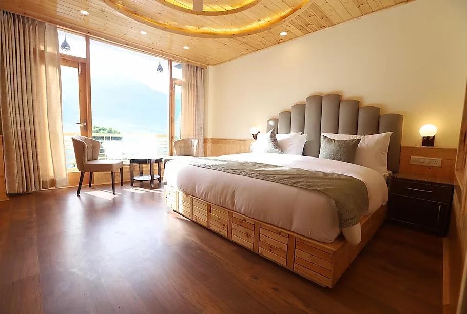 a bed room with seating area at golden wood manali in manali hotel_Image