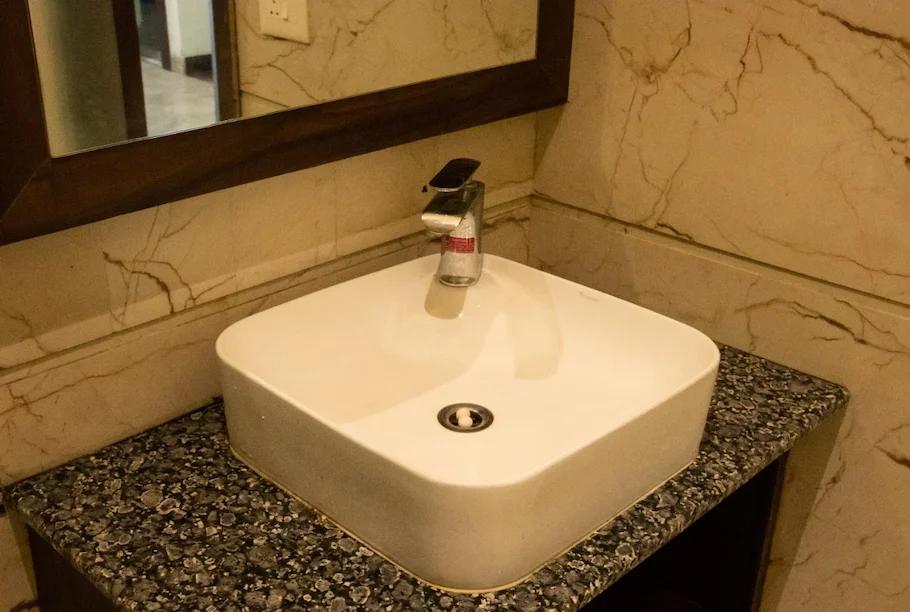 a bathroom with a sink and a mirror at hotel sourav park inn in Agra hotel_Image
