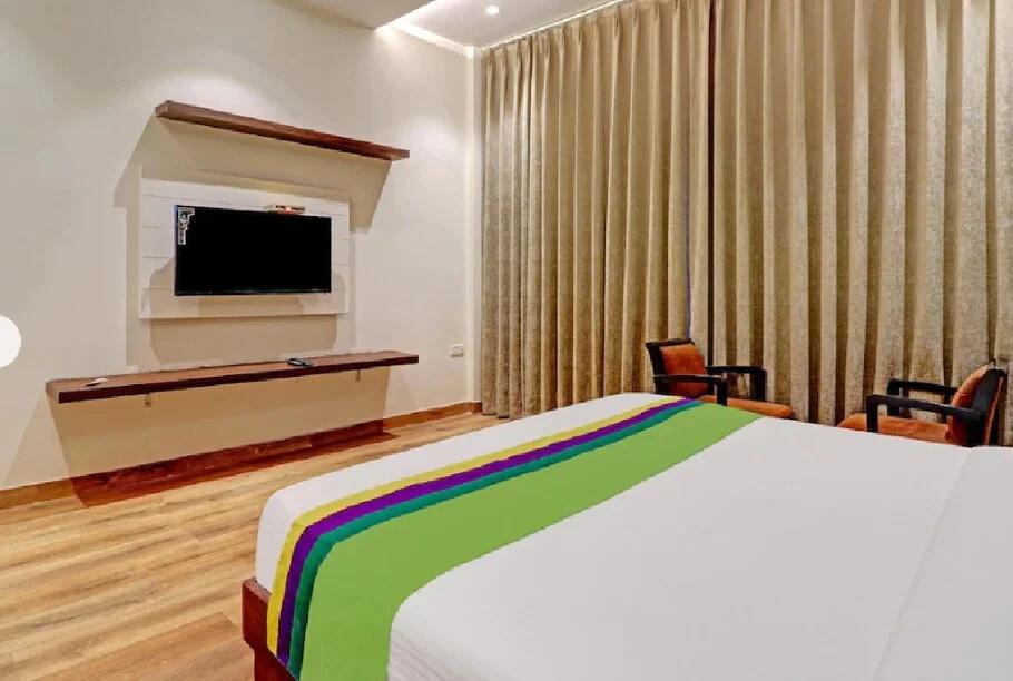 a bedroom with a large bed and a sofa at hotel sourav park inn in Agra hotel_Image