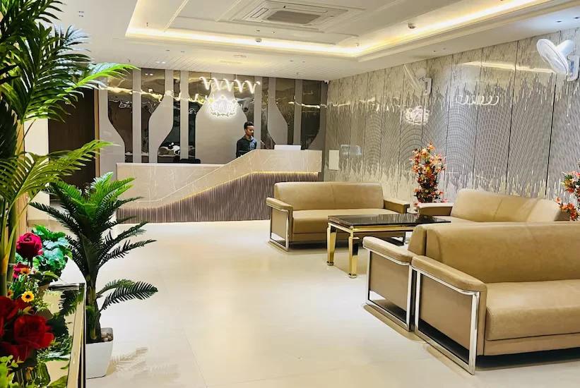 a reception area with seating area and sofa at hotel Aryavilas in Mathura hotel_Image