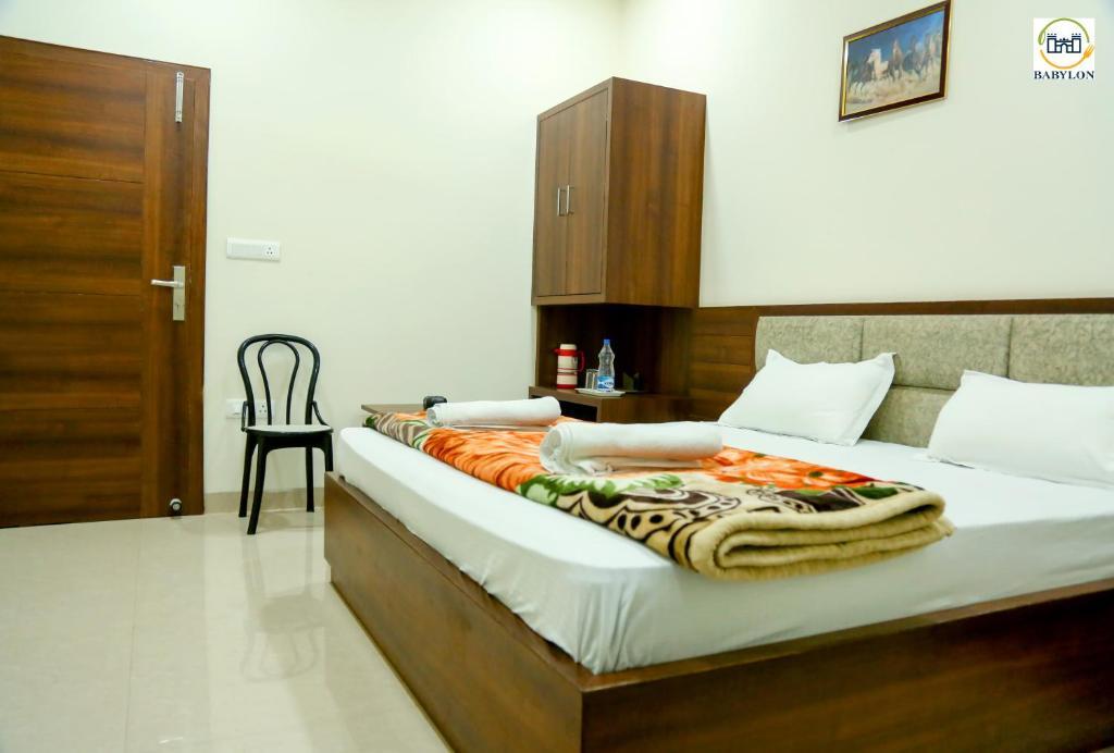 a bed room with t.v at hotel babylon regency in mathura hotel_Image