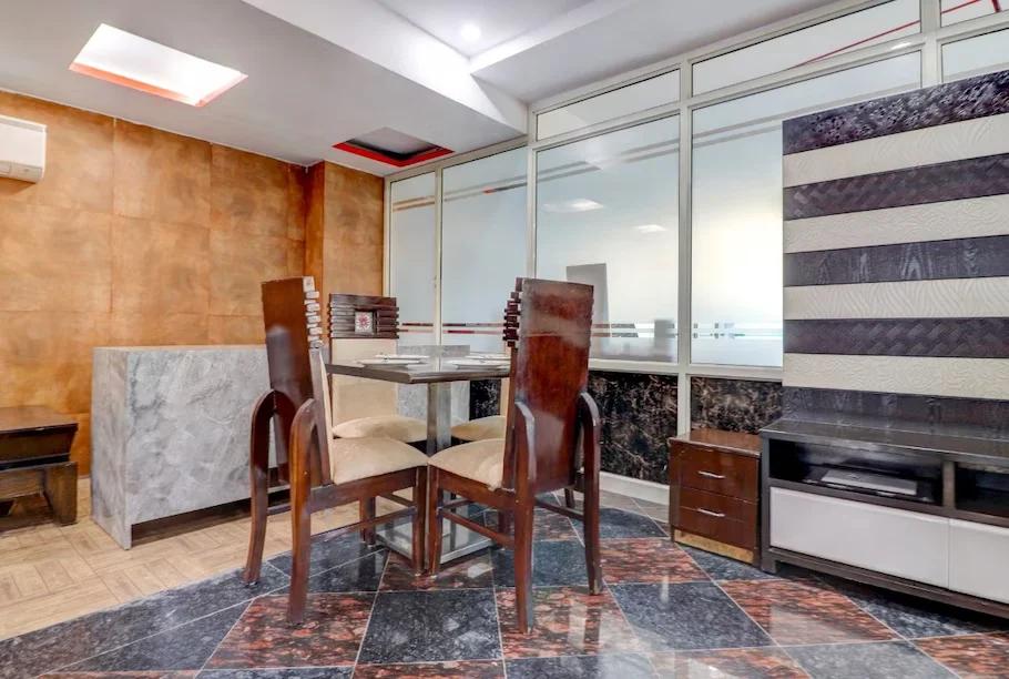 a dinner area with chairs and table at hotel green earth in Gurugram hotel_Image