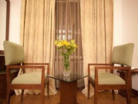 a hotel with sofa and plants at the imperial square in mussoorie hotel_Image