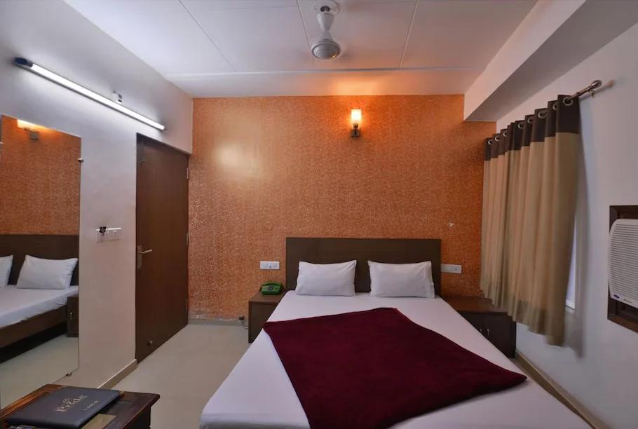 a bedroom with glasses white pillow at hotel pride in chandigarh hotel_Image