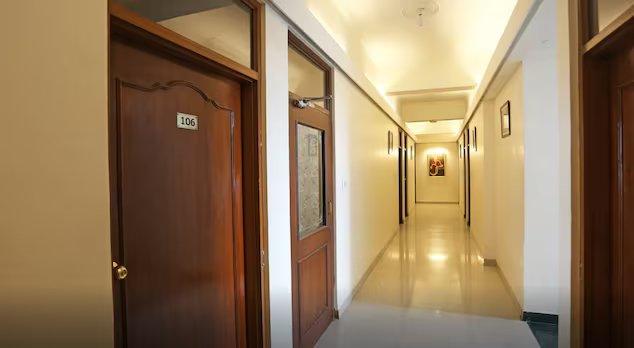 a hallway with wooden door in a building at hotel shree residency in Raipur hotel_Image
