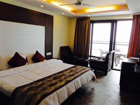 a bedroom with a large bed and sofa at hotel silver star in Mathura hotel_Image