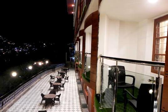 a balcony view with chairs and tables at hotel silver star in Mathura hotel_Image