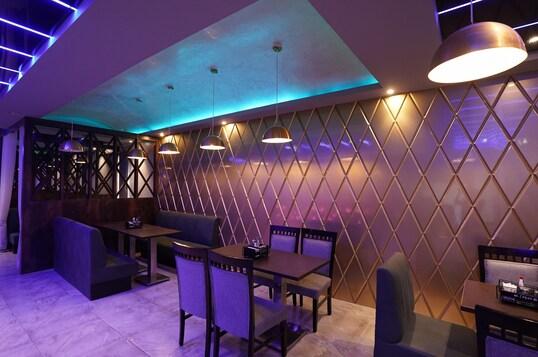 a dinner area with chairs and table at hotel silver star in Mathura hotel_Image