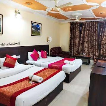 a bedroom with two single bed and a table at hotel star of Kashmir in Srinagar hotel_Image