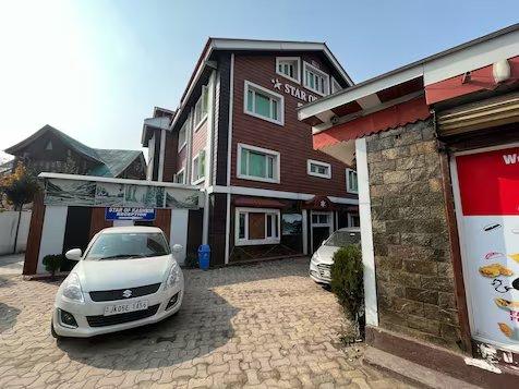 a car parked in front of a hotel with building view at hotel star of Kashmir in Srinagar hotel_Image