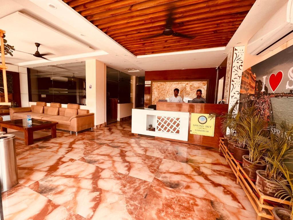 a sofa and help desk at hotel tirath view in Rishikesh hotel_Image