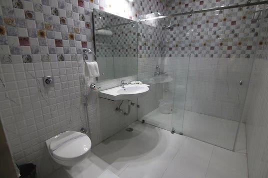 a sink and commode at hotel trinetar gardens banquets in jammu hotel_Image