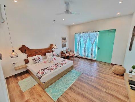 a bedroom with a sofa and a table at mm resort and spa jim corbett in Uttarakhand hotel_Image