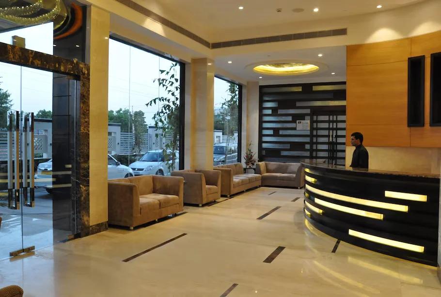 a reception area with sofa and lights at marigold hotel in jaipur hotel_Image