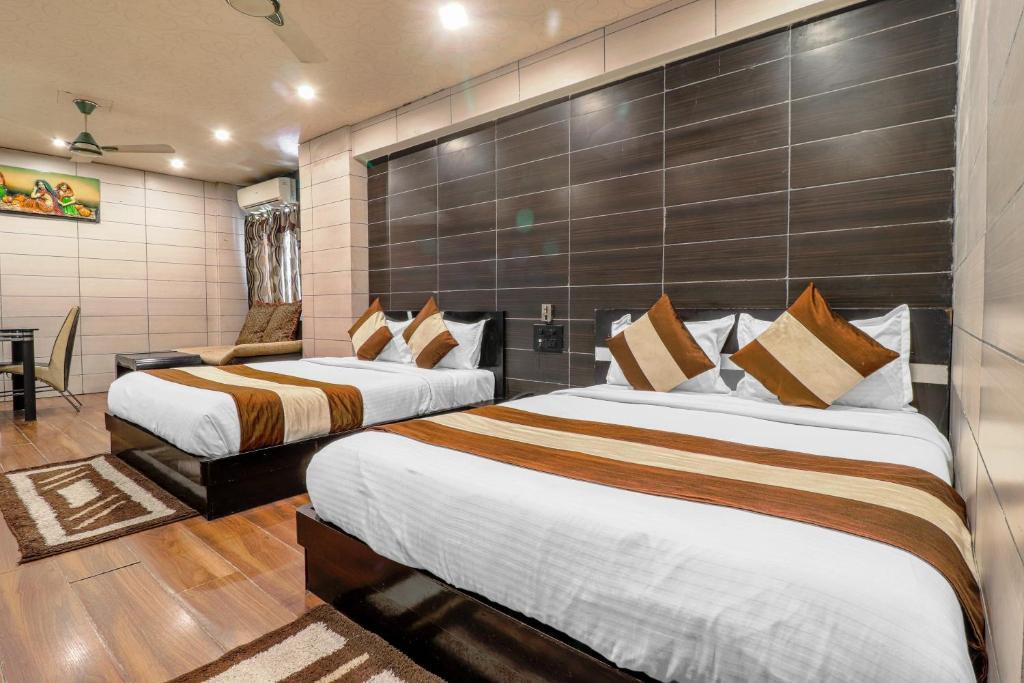 a bedroom with a large bed and a sofa at oaktel hotel la plazo in haridwar hotel_Image