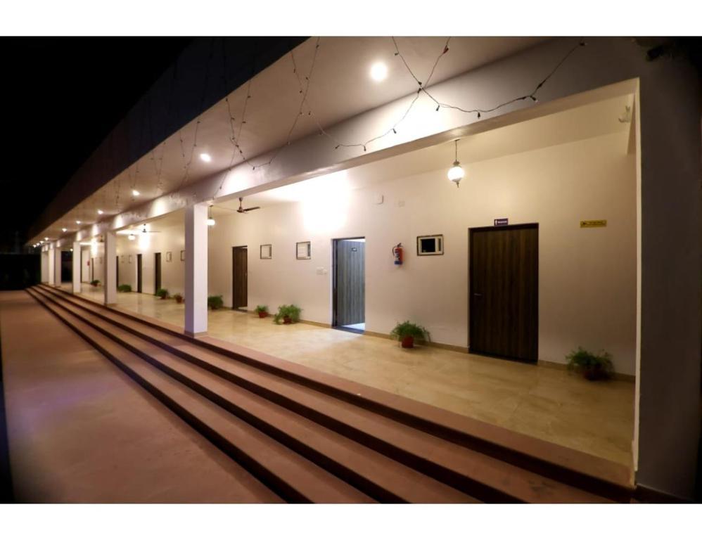 outside view of hotel with lights and plants at rajwada hotel in mathura hotel_Image