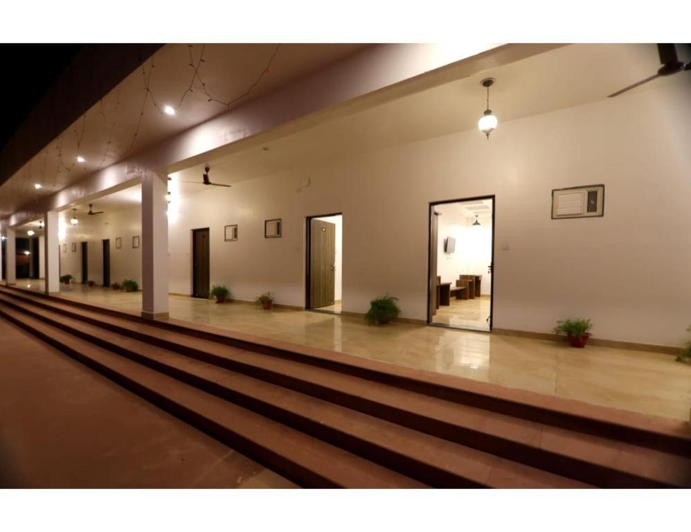 outside view of hotel with lights and plants at rajwada hotel in mathura hotel_Image