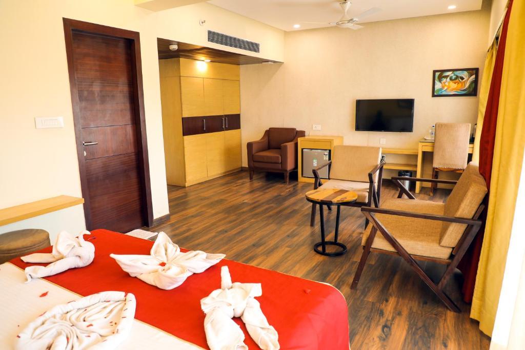 a bedroom with a sofa at Rosetum Anjuna in Goa hotel_Image