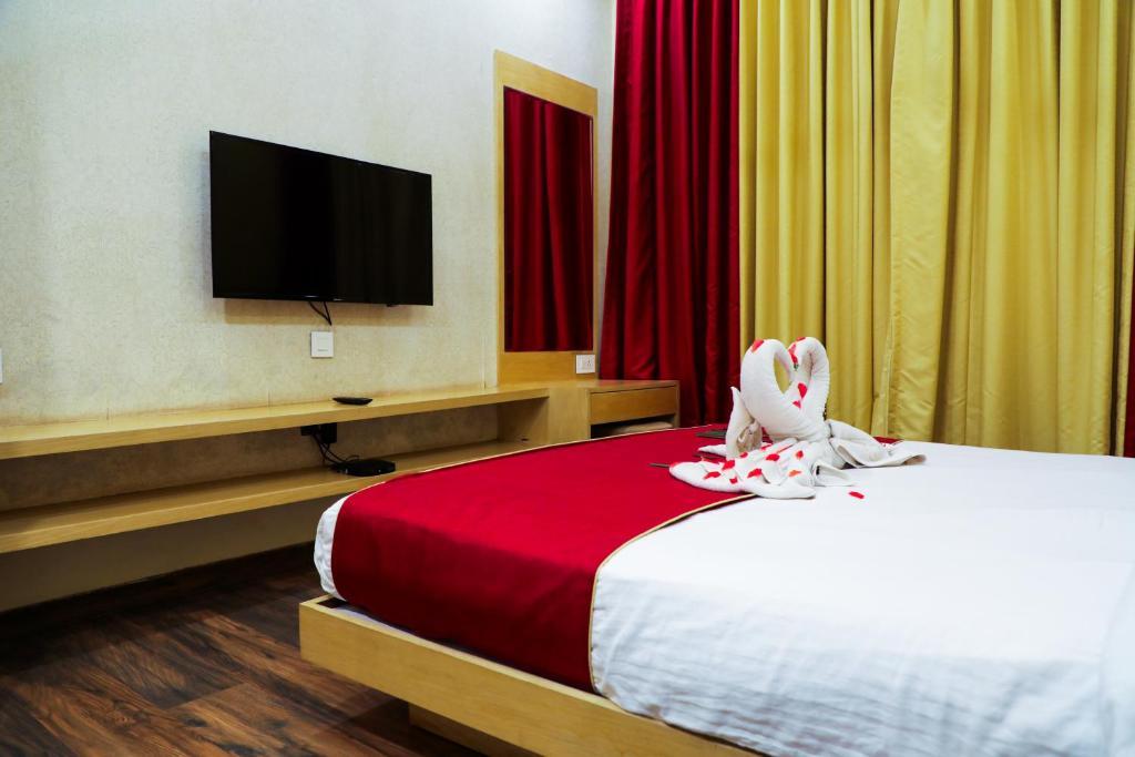 a bedroom with a tv at Rosetum Anjuna in Goa hotel_Image
