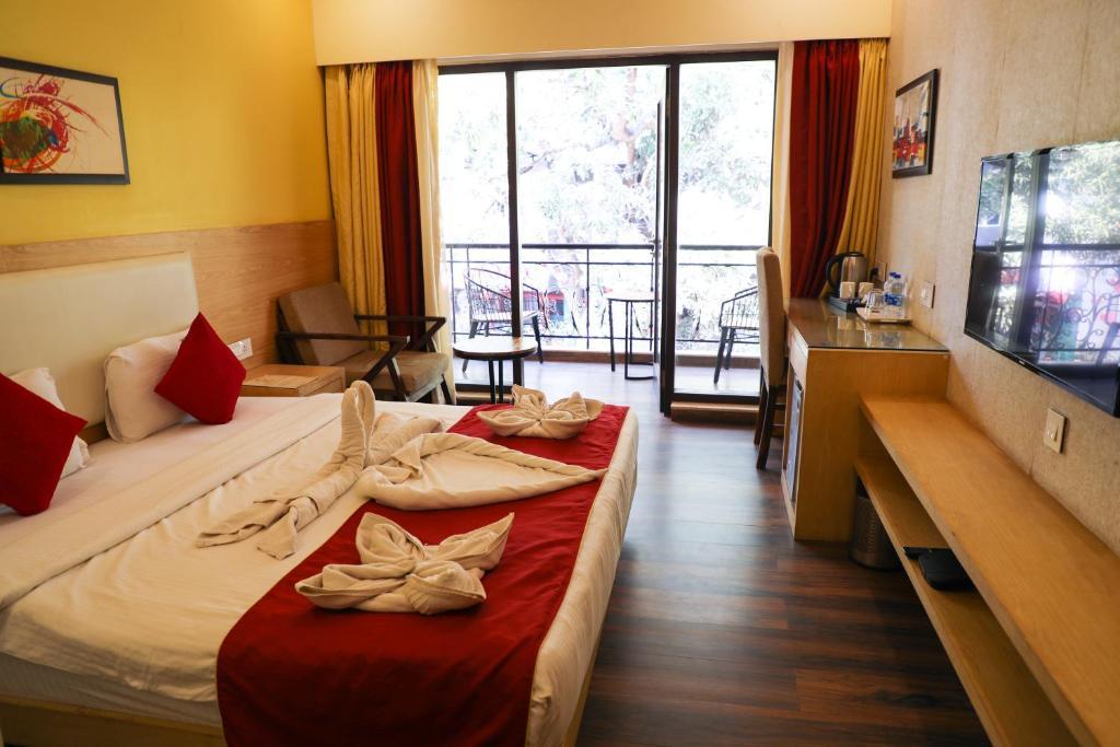 a bedroom with a sofa at Rosetum Anjuna in Goa hotel_Image