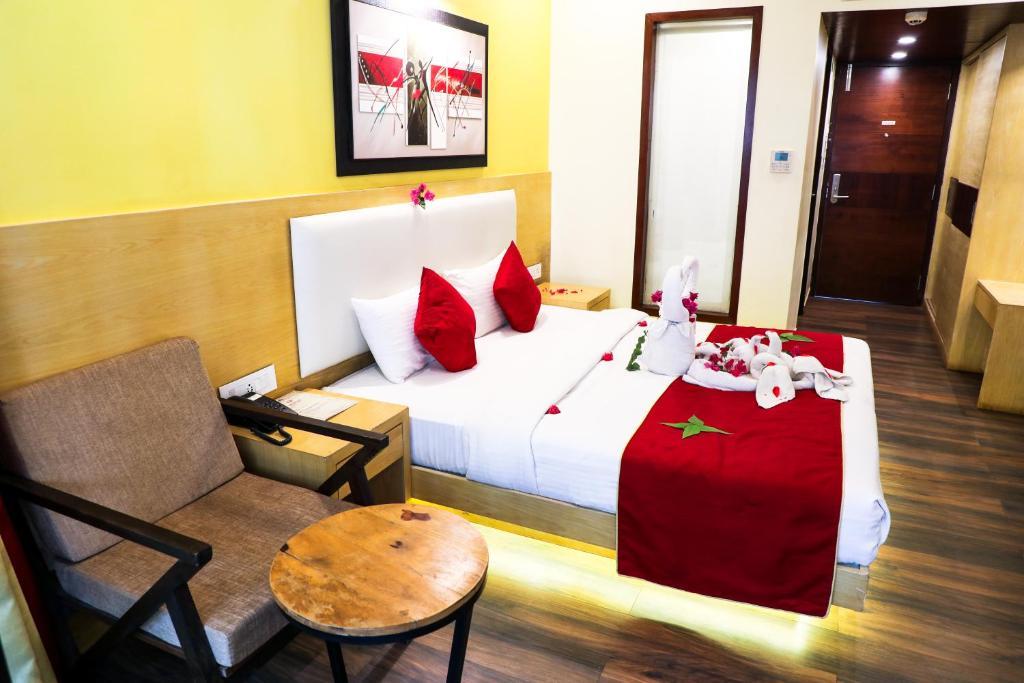 a bedroom with a sofa at Rosetum Anjuna in Goa hotel_Image