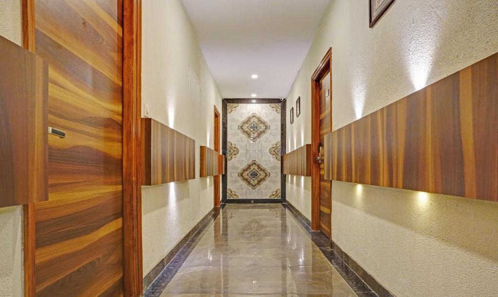 a hallway with wooden door in a building at sanskar prime hotel in jaipur hotel_Image