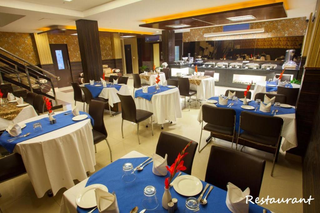 a hotel with dinner area and chairs at skylark hotel by gabrian hotel in gurugram hotel_Image