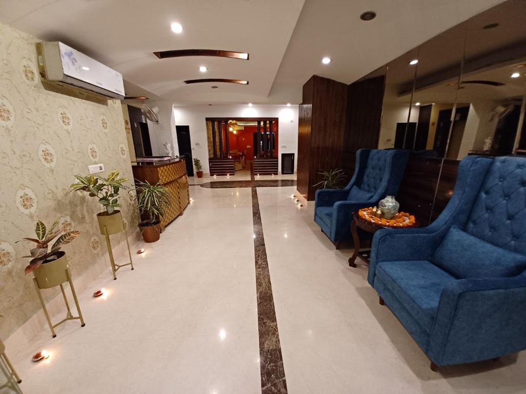 a reception area with plants and sofa at skylark hotel by gabrian hotel in gurugram hotel_Image