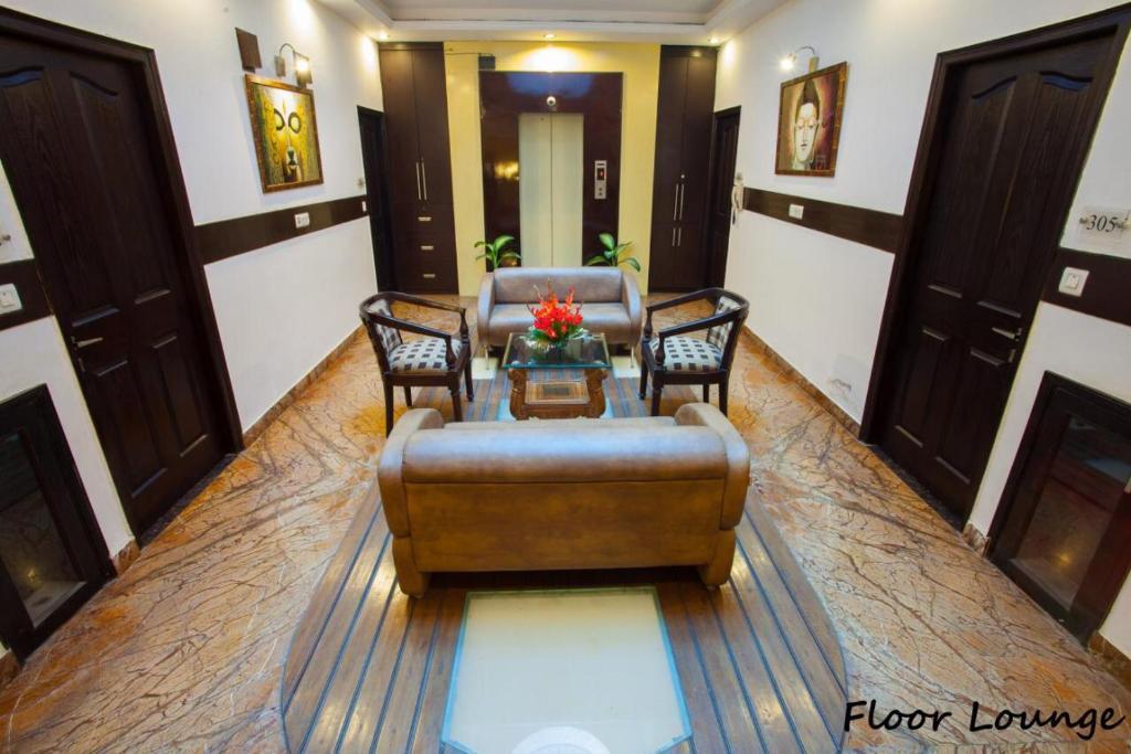 a hotel meeting area with sofa chairs and table at skylark hotel by gabrian hotel in gurugram hotel_Image