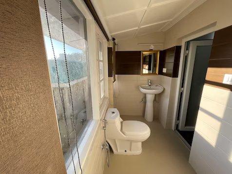 a bathroom with a toilet and a sink at the haritage hotel in shimla hotel_Image