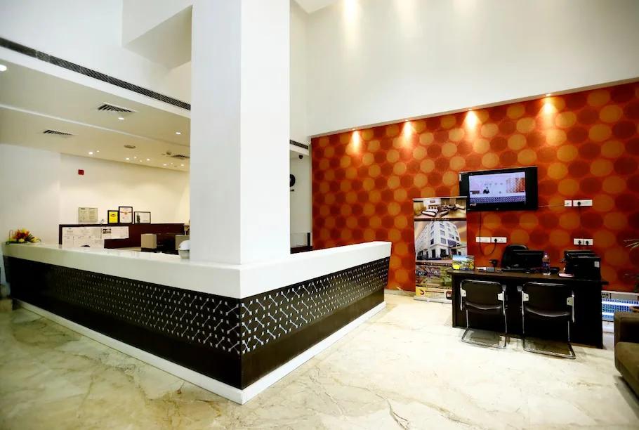 a reception area with chair and table at the grand radiant in lucknow hotel_Image