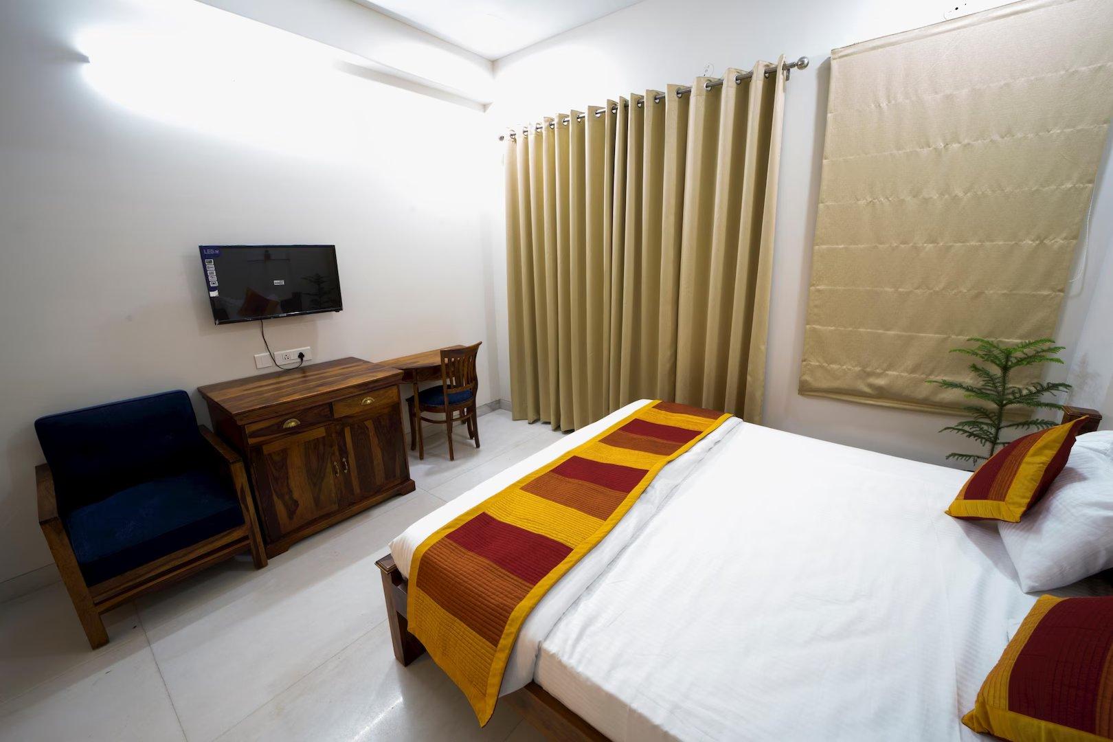 a bedroom with a large bed and tv at the raas mahal hotel in jaipur hotel_Image
