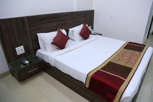 a bedroom with a large bed and pillows at the royal bharti in vrindavan hotel_Image