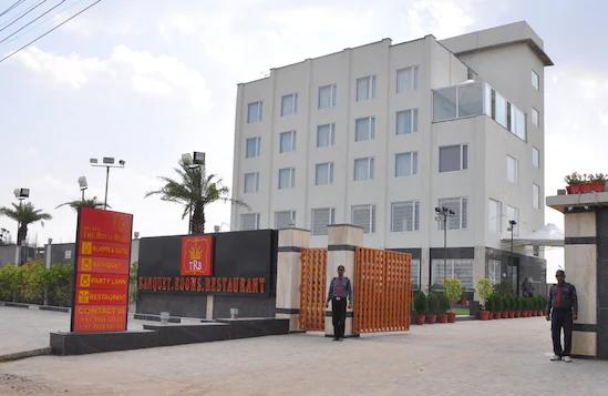 a hotel view with security guard and garden view at the royal bharti in vrindavan hotel_Image