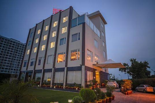 a hotel night view with garden and car parked at the royal bharti in vrindavan hotel_Image