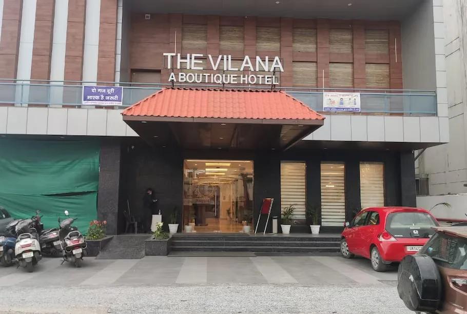 the hotel name & logo with car parked front of it at the vilana luxurious hotel in rishikesh hotel_Image