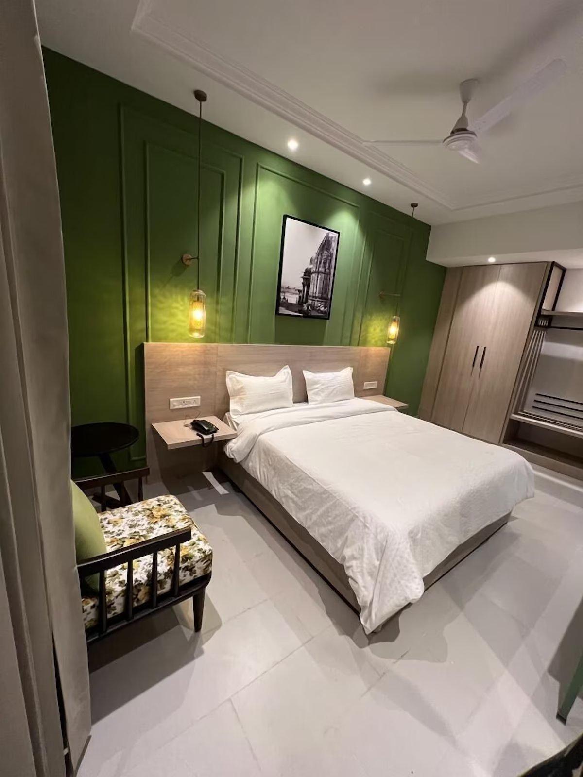 a hotel bedroom with sofa and table at wonder hill hotel in haridwar hotel_Image