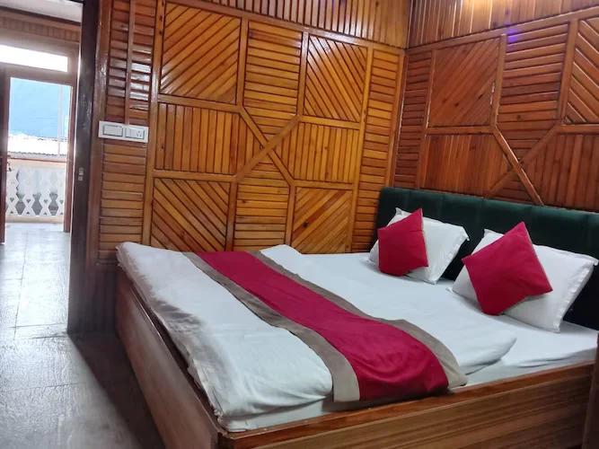 a bed room with chair at hill view in nainital hotel_Image