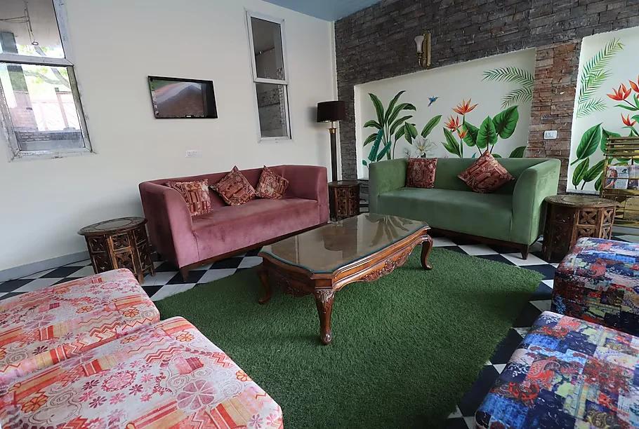 a meeting area with sofa and table at park exotica resort in jaipur hotel_Image