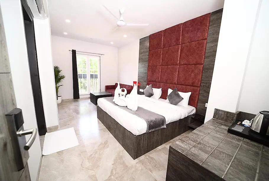a bedroom with four pillows and plants at thor hotel in agra hotel_Image
