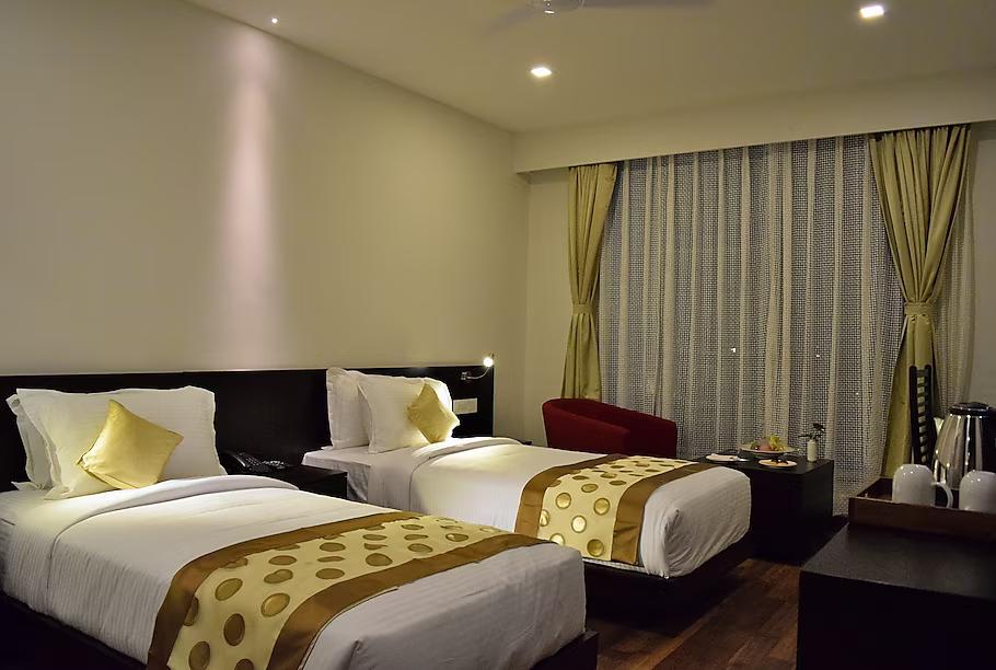a double bedroom with sofa & pillow at vesta grand central in Udaipur hotel_Image